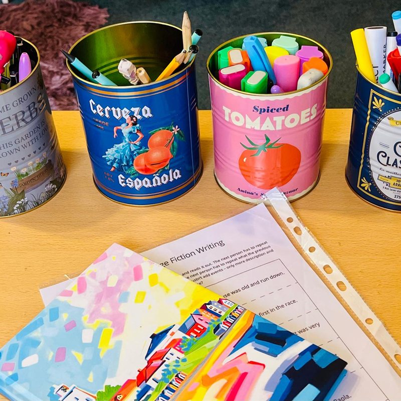 Pens and writing resources - Saffron Primary Tutoring Pots of colourful pens and pencils with a creative writing worksheet at Saffron Primary Tutoring in Saffron Walden